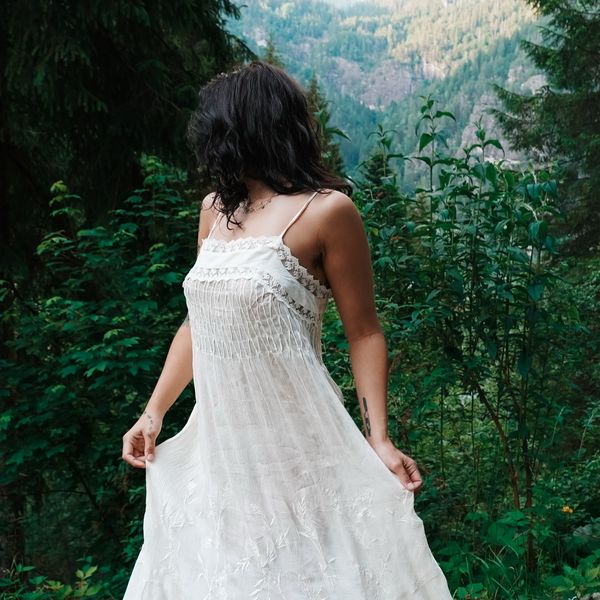 Ivy twirling her sundress on a mountain trail